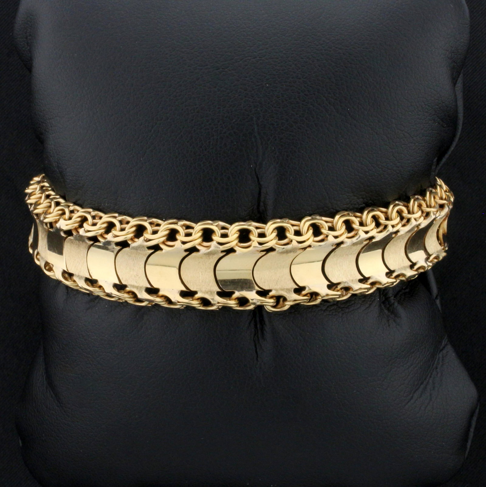 Wide Designer Link Bracelet in 18K Yellow Gold: In 18K Yellow Gold. 7 1/2 inches long. 13.8mm wide. With safety clasp and safety chain. 29.9g