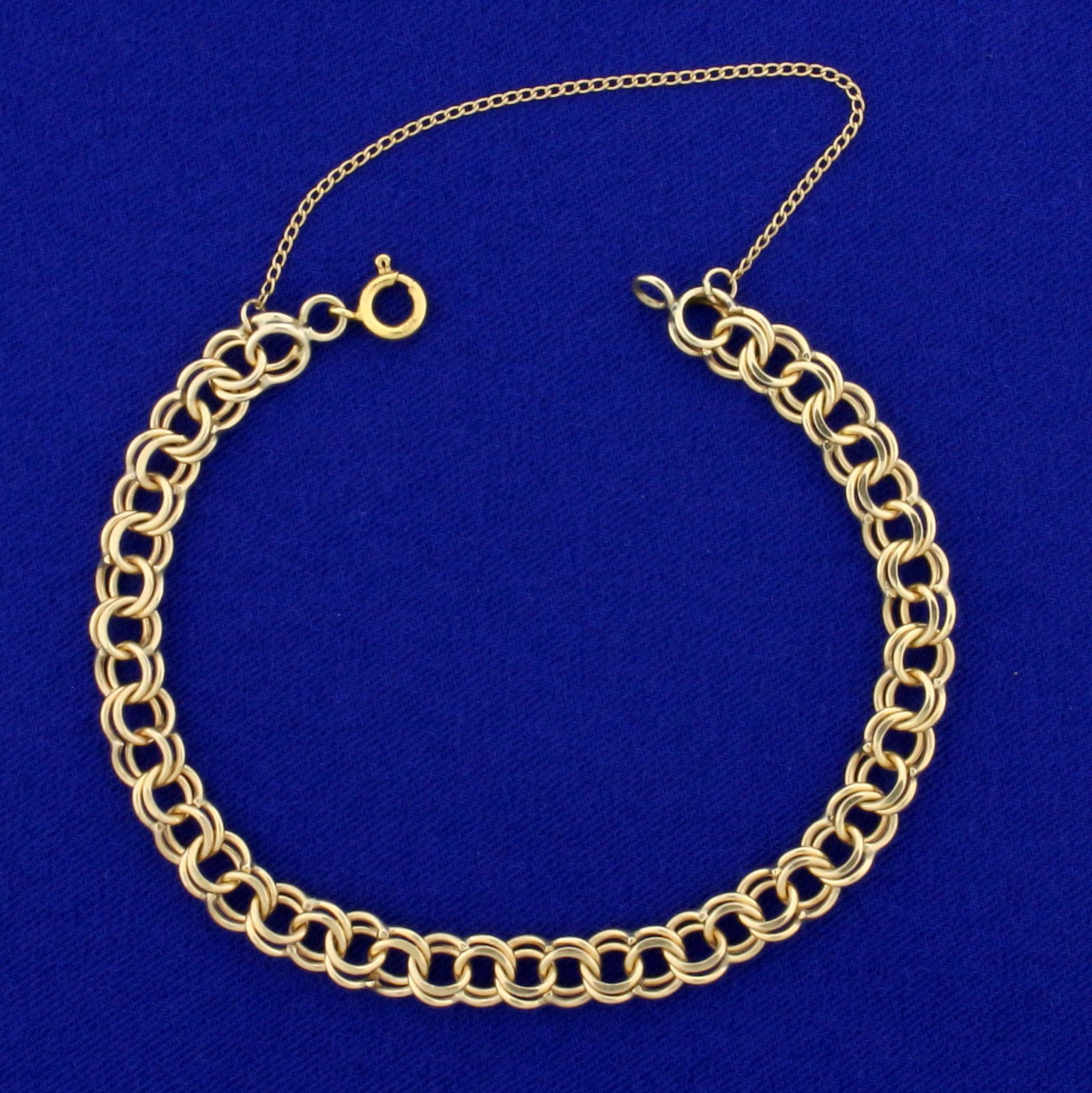 Double Loop Charm Bracelet in 14K Yellow Gold: In 14K Yellow Gold. 7 1/4 inches long, 6.3mm wide. With safety chain. 9.0g.
