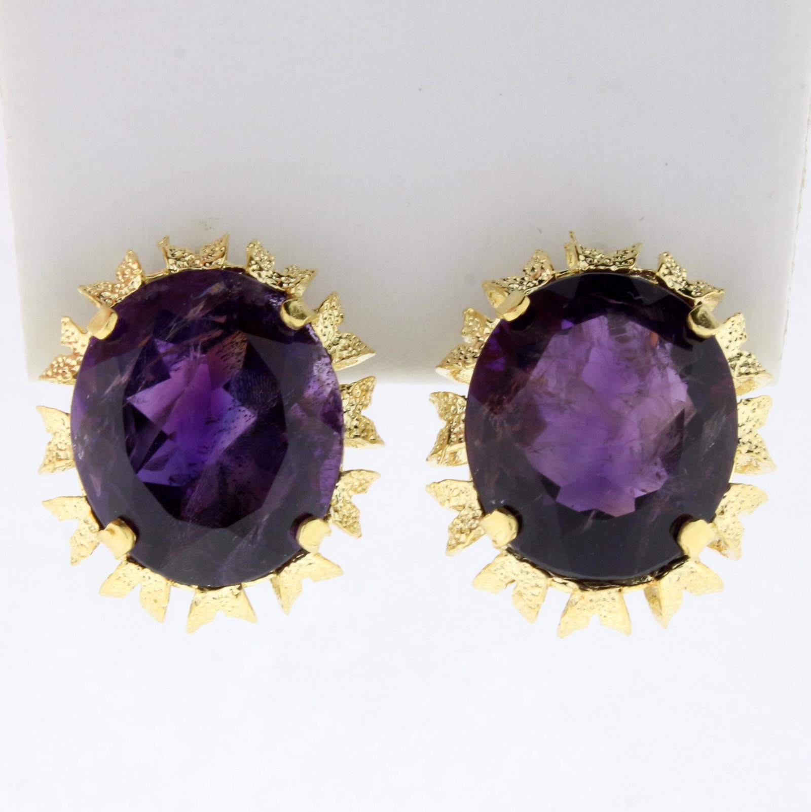 16ct TW Oval Amethyst Statement Earrings in 18K Yellow: In 18K Yellow Gold. Each earring contains one high quality natural 15.5x13.5mm oval Amethyst gemstone with intense purple color. Omega lever backs. 10.3g