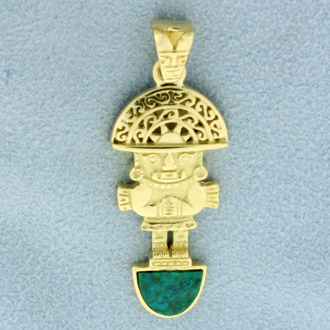Peruvian Tumi Pendant in 18k Yellow Gold: In 18k Yellow Gold. Contains one high quality natural 6.5x 8.5mm Peruvian Turquoise gemstone. 1 3/4 inches long. 3/4 inch wide. 6.9g