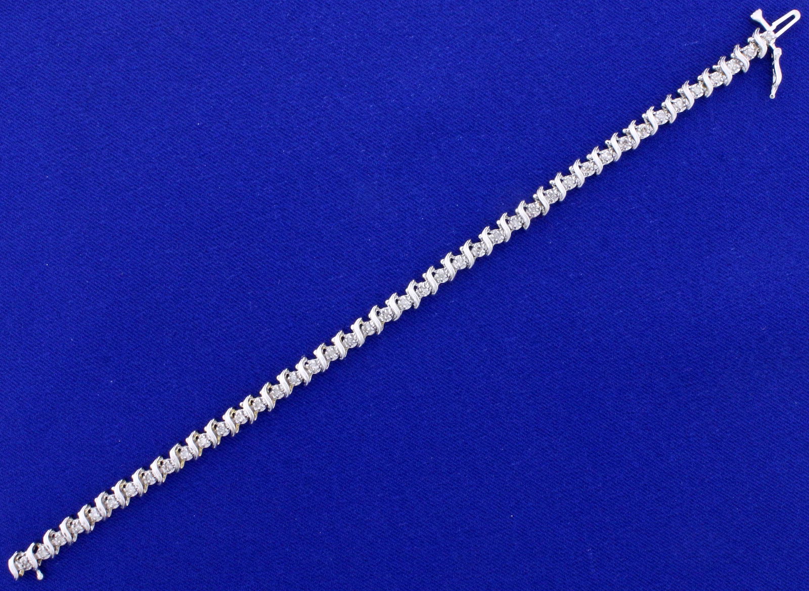 1/2ct TW Diamond Tennis Bracelet in 14k White Gold: In 14k white gold. Contains 1/2 ct TW of high quality diamonds, I color/I clarity. 7 1/4" long, with safely clasp. 8.3g.
