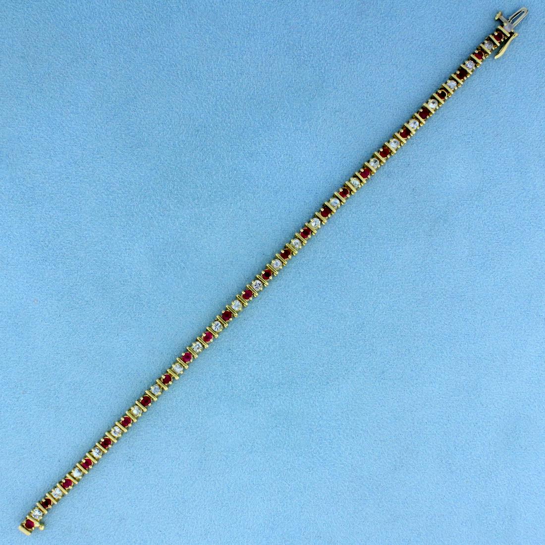 3ct TW Ruby and Diamond Tennis Bracelet in 10K Yellow: In 10K Yellow Gold. Contains twenty-five high quality natural 2.5mm Ruby gemstones with bright pink red color. Also contains twenty-five high quality .06ct diamonds with SI clarity/H color. 7 1/2 inch