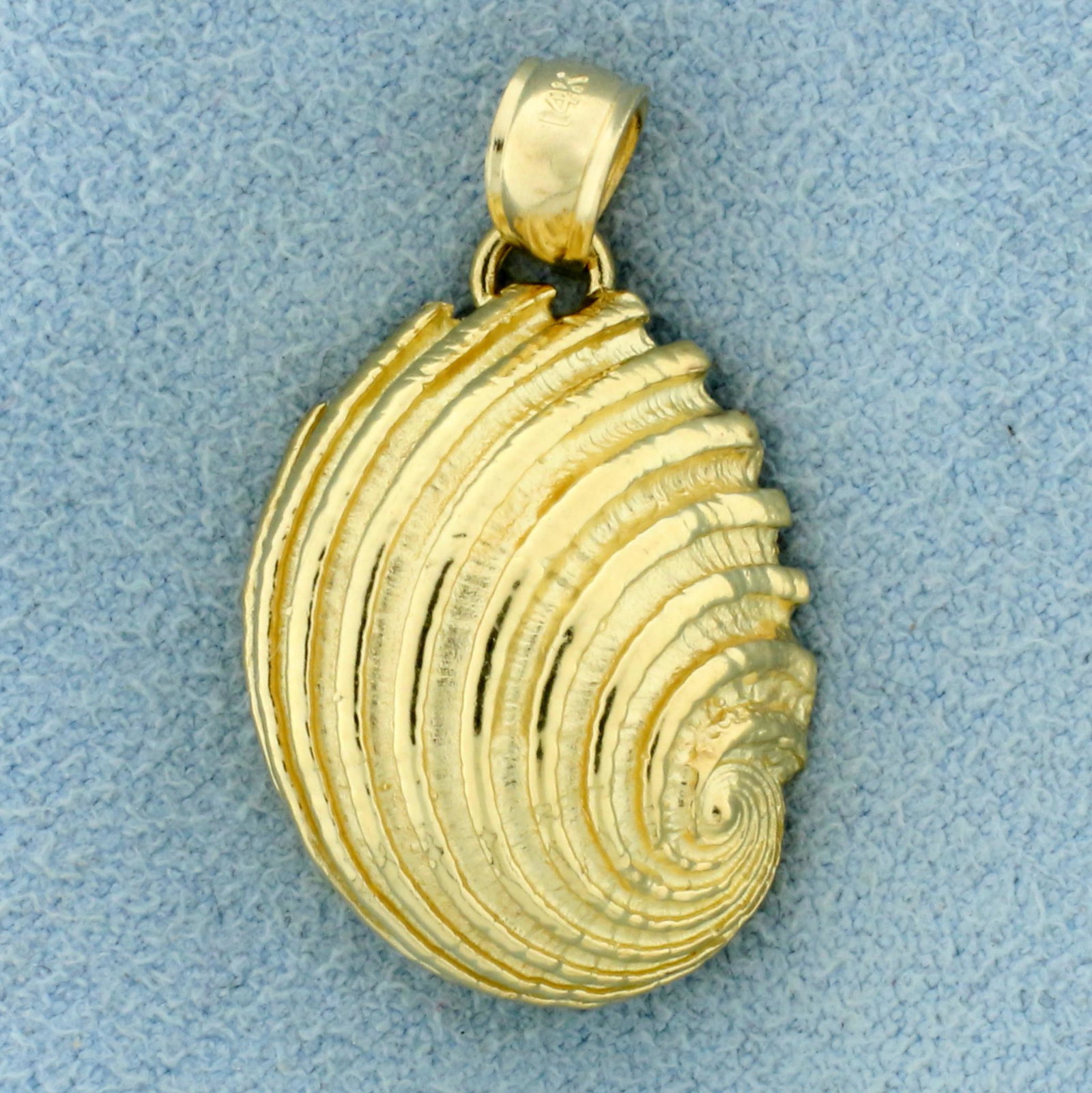 Seashell Pendant or Charm in 14K Yellow Gold: In 14K Yellow Gold. 1 1/8 inches long, 11/16 inch wide. 4.5g.