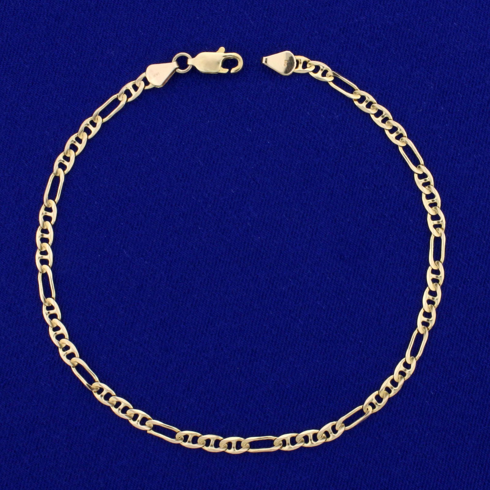 9 1/4 Inch Figarucci Link Anklet in 14K Yellow Gold: In 14K Yellow Gold. 9 1/4 inches long, 3.2m wide. Lobster clasp. 3.7g.