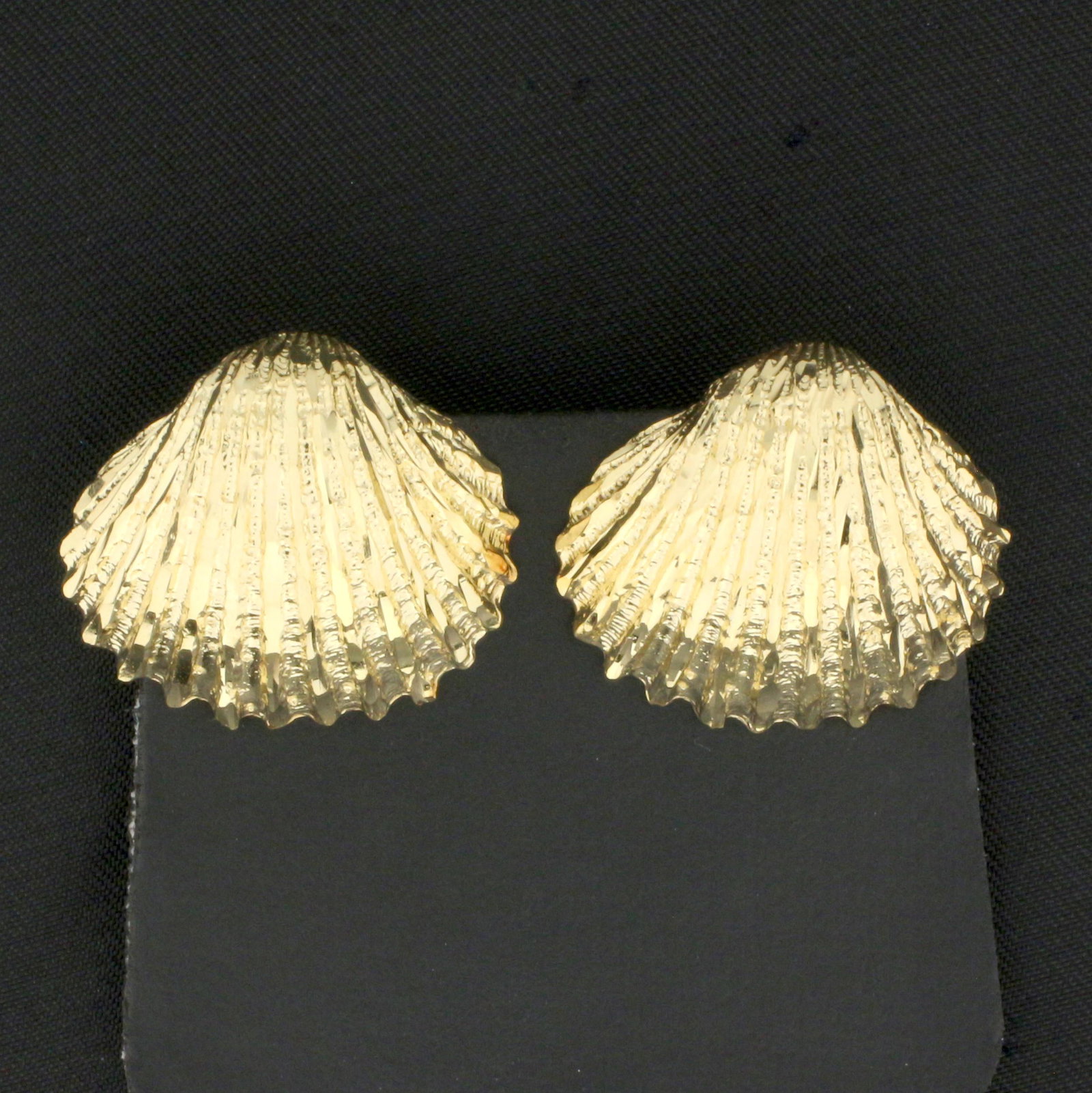 Seashell Clip-On Earrings in 14K Yellow Gold: In 14K Yellow Gold. 3/4 inch long, 7/8 inch wide. 9.9g.