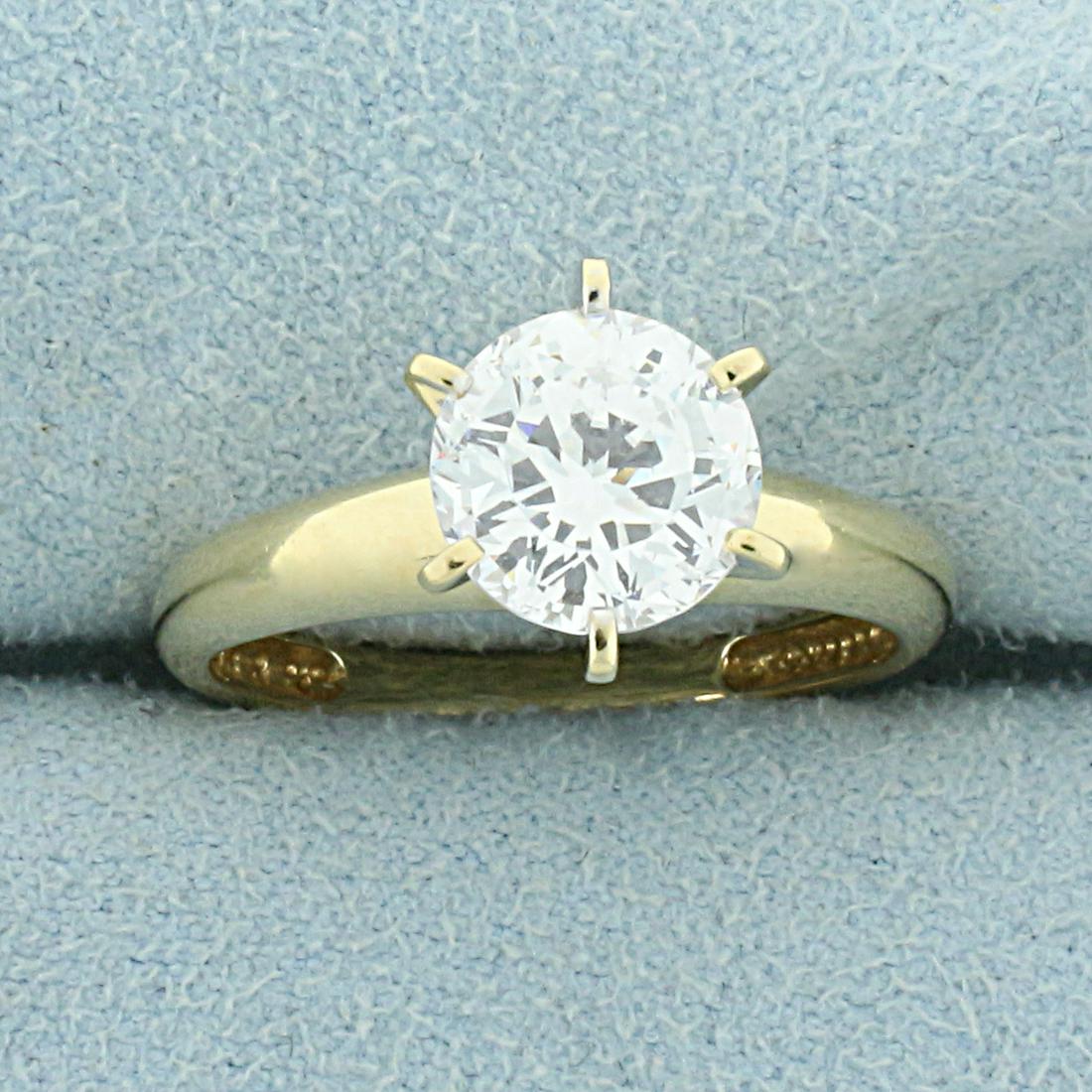 2CT Solitaire CZ Engagement Ring in 14K Yellow Gold: In 14K Yellow Gold. Contains one high quality natural 2ct round CZ gemstone with lots of sparkle and excellent clarity. Size 7 1/2. 3.2g.