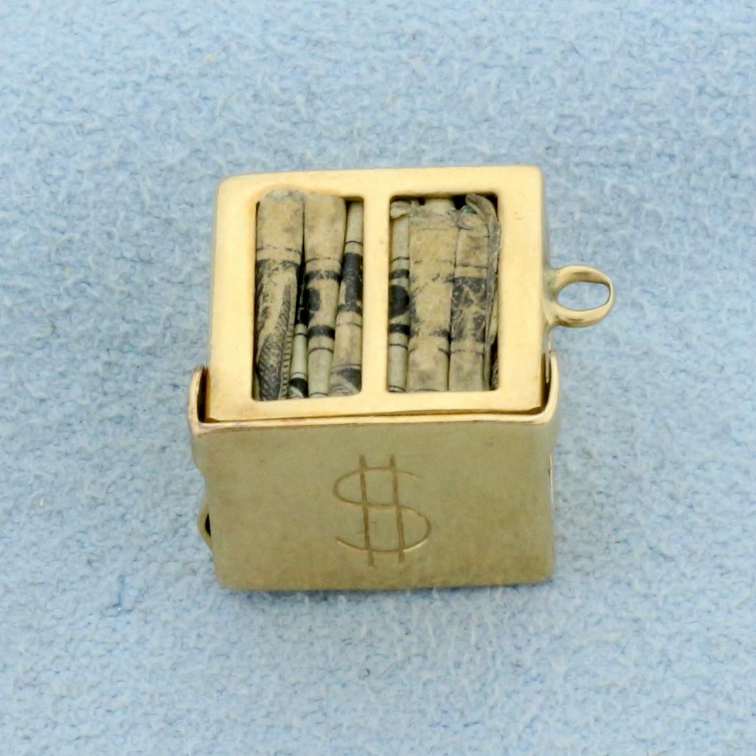 Money Charm or Pendant in 14K Yellow Gold: In 14K Yellow Gold. 5/8 inch long including bale, 9/16 inch wide. 3.5g.