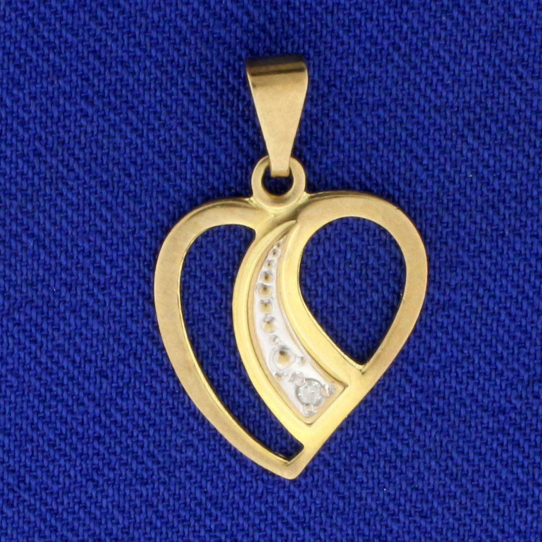 Diamond Heart Pendant in 8K Yellow Gold: In 8K Yellow Gold. 7/8 inch ling including bale. 9/16 inch wide. Contains one high quality .01ct round cut Diamond. .7g