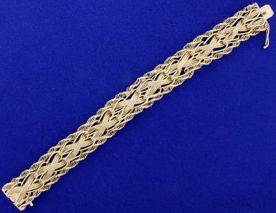 7 1/8 Inch Wide Designer Bracelet in 14K Yellow Gold: In 14K Yellow Gold. 7 1/8 inches long, 15.2mm wide. 23.9g.