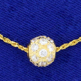 1ct TW White Sapphire Ball Pendant and Chain in 18K: In 18K Yellow Gold. Contains twenty-one high quality .05ct white sapphires with bright white color, excellent clarity, and lots of sparkle. Rope chain is 15 3/4 inches long and 1.4mm thick. 