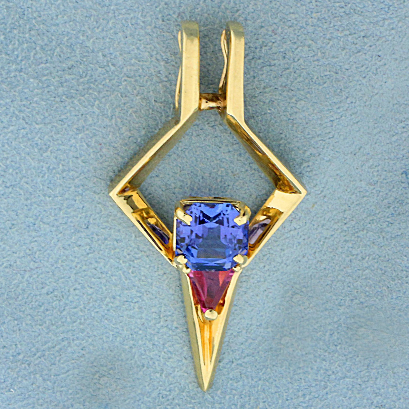 Modernist Tanzanite and Morganite Pendant in 14K Yellow: In 14K Yellow Gold. Contains one high quality natural 8mm cushion cut Tanzanite gemstone, approximately 2.25cts, with intense purple/blue color and excellent clarity. Also contains one high quality na