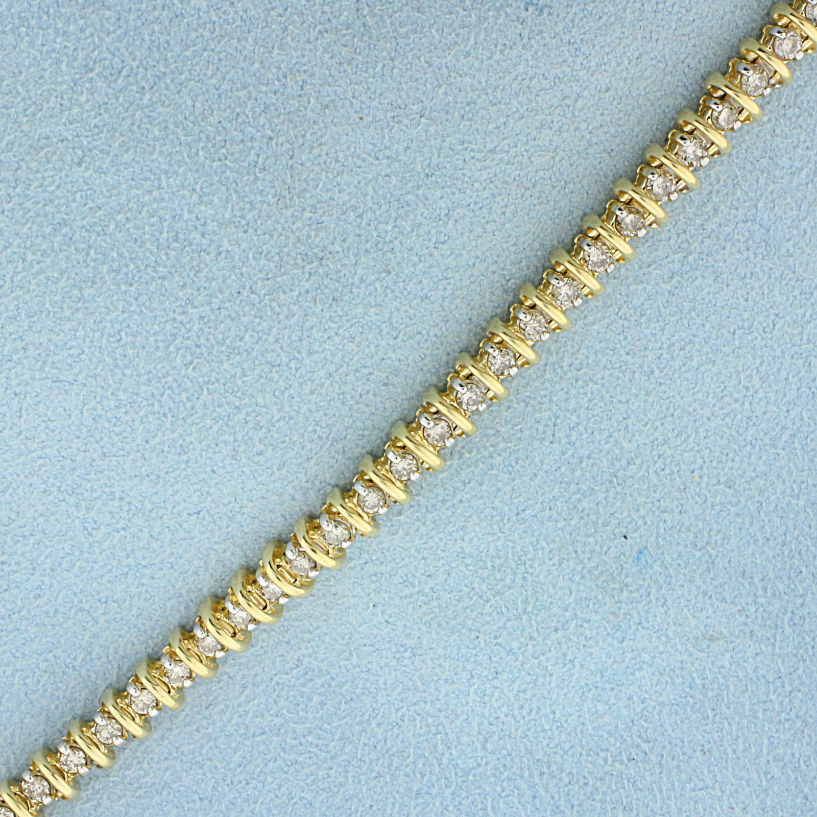 2ct TW Champagne Diamond Tennis Bracelet in 14K Yellow: In 14K yellow Gold. Contains fifty high quality .04ct round Champagne Diamonds with warm color and lots of sparkle. With safety clasp. 7 inches long. 4.8mm wide. 13.7g