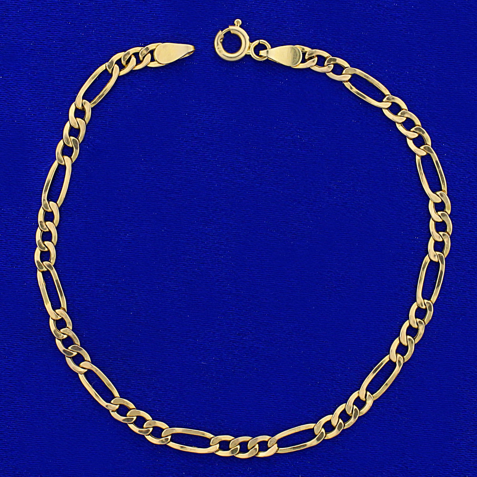 7 Inch Figaro Link Chain Bracelet in 14K Yellow Gold: In 14K Yellow Gold. 7 inches long, 3.3mm wide, with spring clasp. 1.4g.