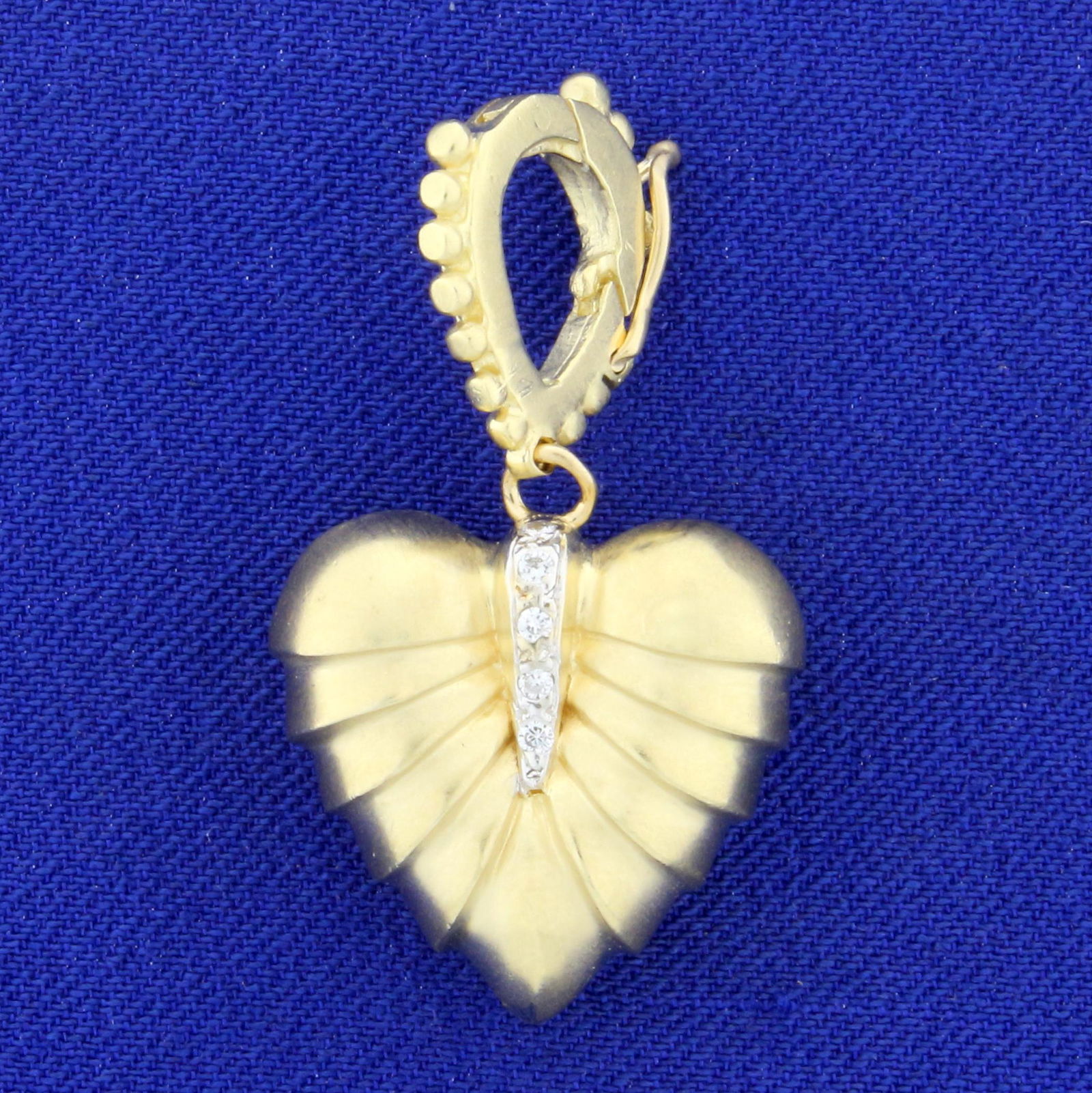 Vintage Solid Gold and Diamond Heart Pendant in 14K: In 14K Yellow Gold. 1 3/8 inches long with openable bale. Contains ten high quality 1/2pt round diamonds. 9.3g.