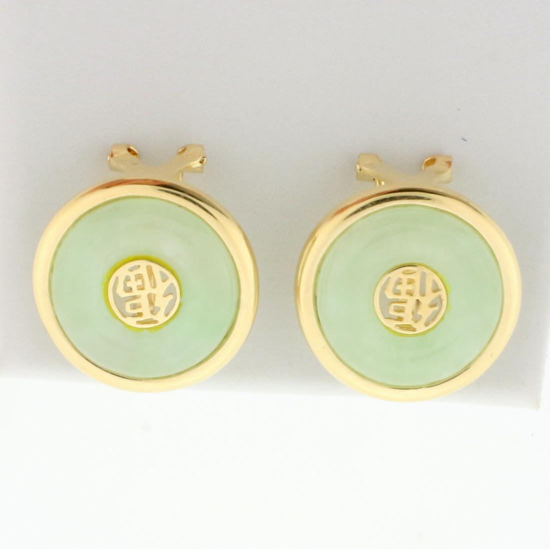 Jade Good Fortune Earrings in 14K Yellow Gold: In 14K Yellow Gold. Contains one high quality natural 13mm Jade gemstone with beautiful light green color. Chinese symbol for good fortune. 11/16 inch diameter. French Omega backs for pierced ears. 4.