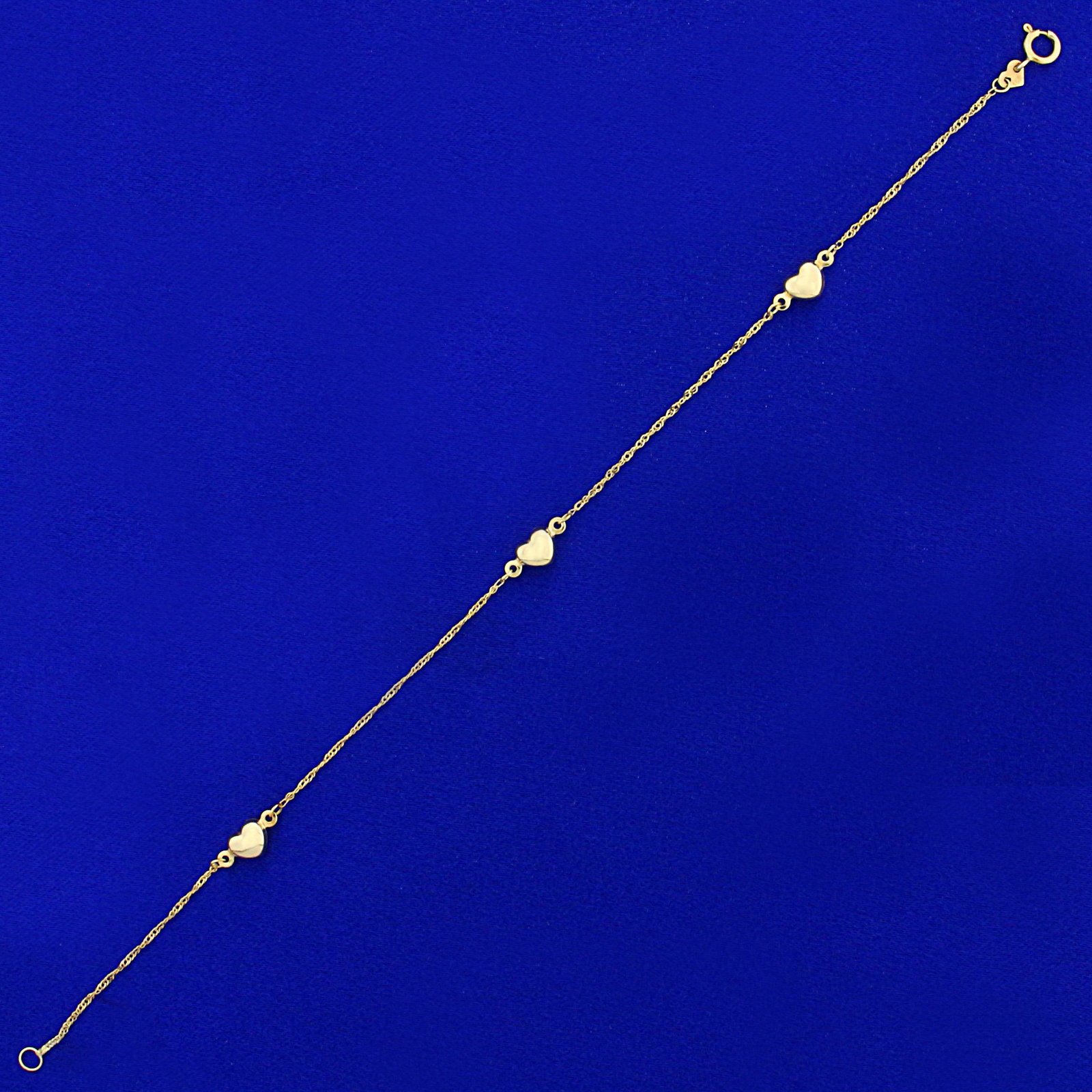 Heart Chain Bracelet in 14K Yellow Gold: In 14K Yellow Gold. 7 3/4 inches long, Hearts are 4.9mm long. 1.0g.