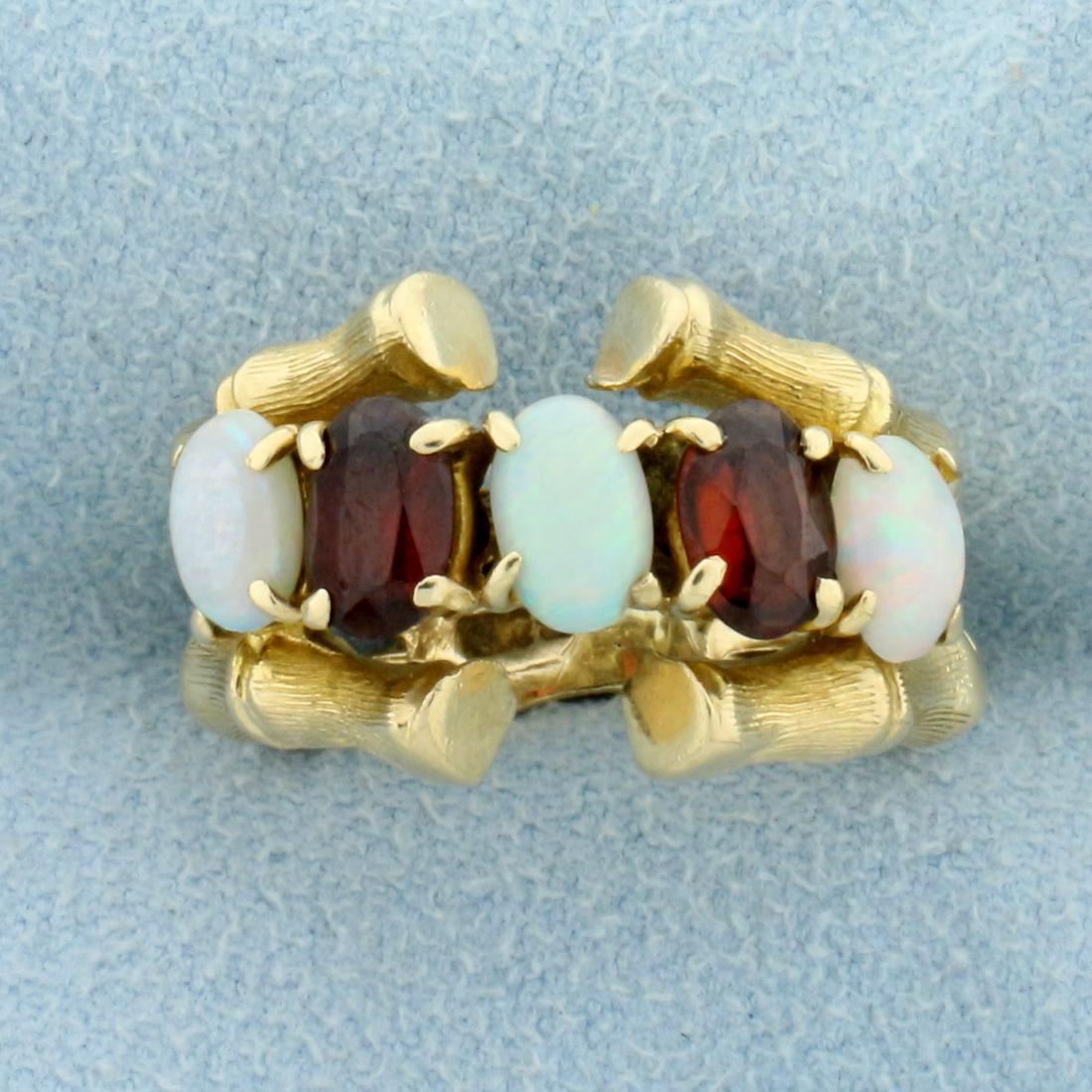 2.5ct TW Natural Opal and Garnet Ring in 14K Yellow: In 14K Yellow Gold. Contains three high quality natural 6x4mm oval Opal gemstones with flashes of green, orange, and purple. Also contains two high quality natural 6x4mm oval Garnet gemstones with war