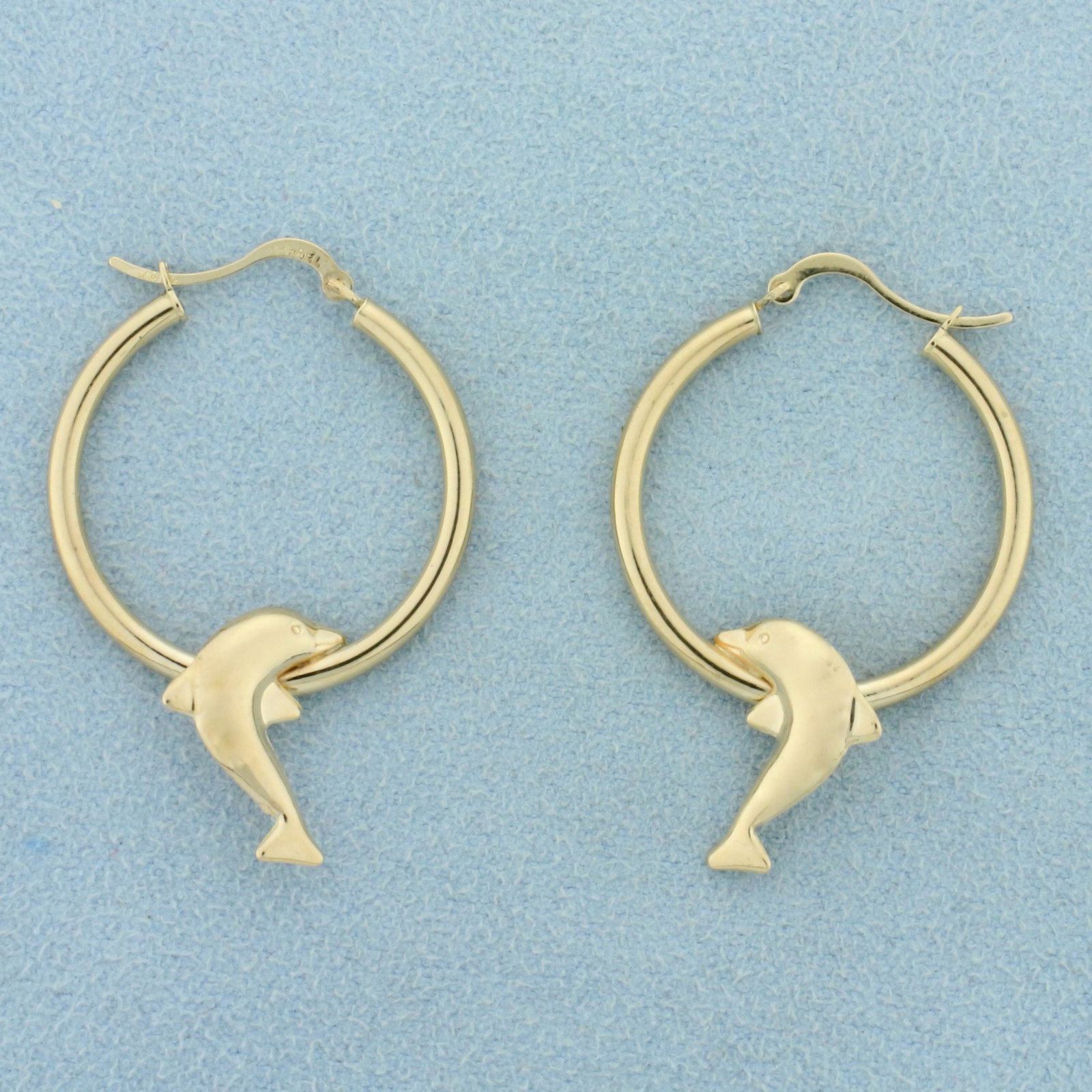Dolphin Hoop Earrings in 10K Yellow Gold: In 10K Yellow Gold. 1 1/2 inches long. 2mm wide. 1.3g