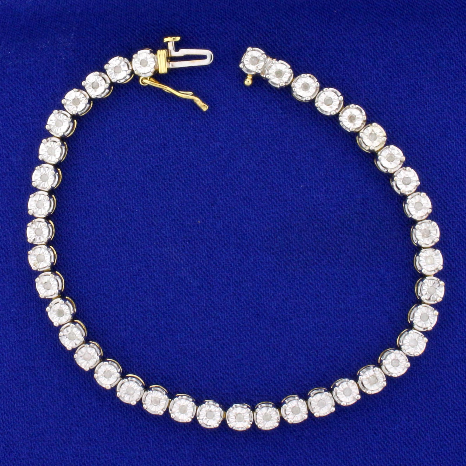 Diamond Tennis Bracelet in Gold Plated Sterling Silver: In Gold Plated .925 Sterling Silver. Contains forty high quality 1/2pt Diamonds. 7 1/2 inches long. 12.0g