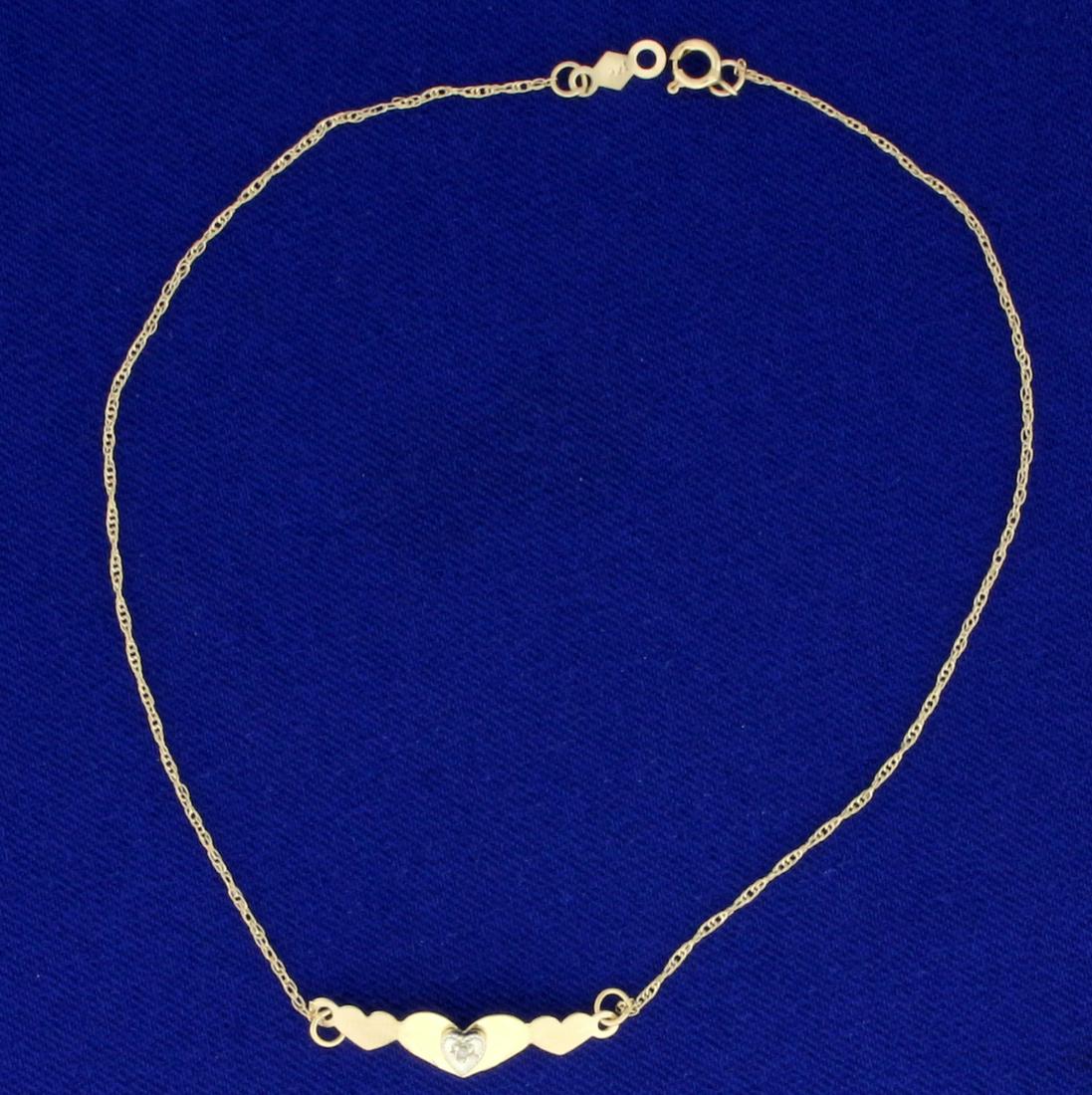 Diamond Heart Anklet in 14K Yellow Gold: In 14K Yellow Gold. Contains a 1/2pt round Diamond. 9 1/4 inches long, with spring clasp. 0.8mm wide chain. 0.6g