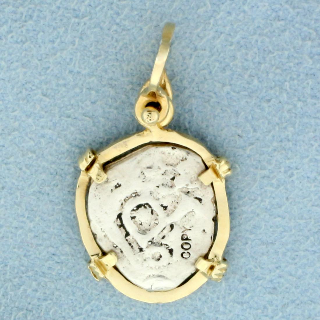 Replica Old Spanish Coin Pendant in 14K Yellow Gold: In 14K Yellow Gold. 1 inch long. 3/4 inch wide. 2.8g