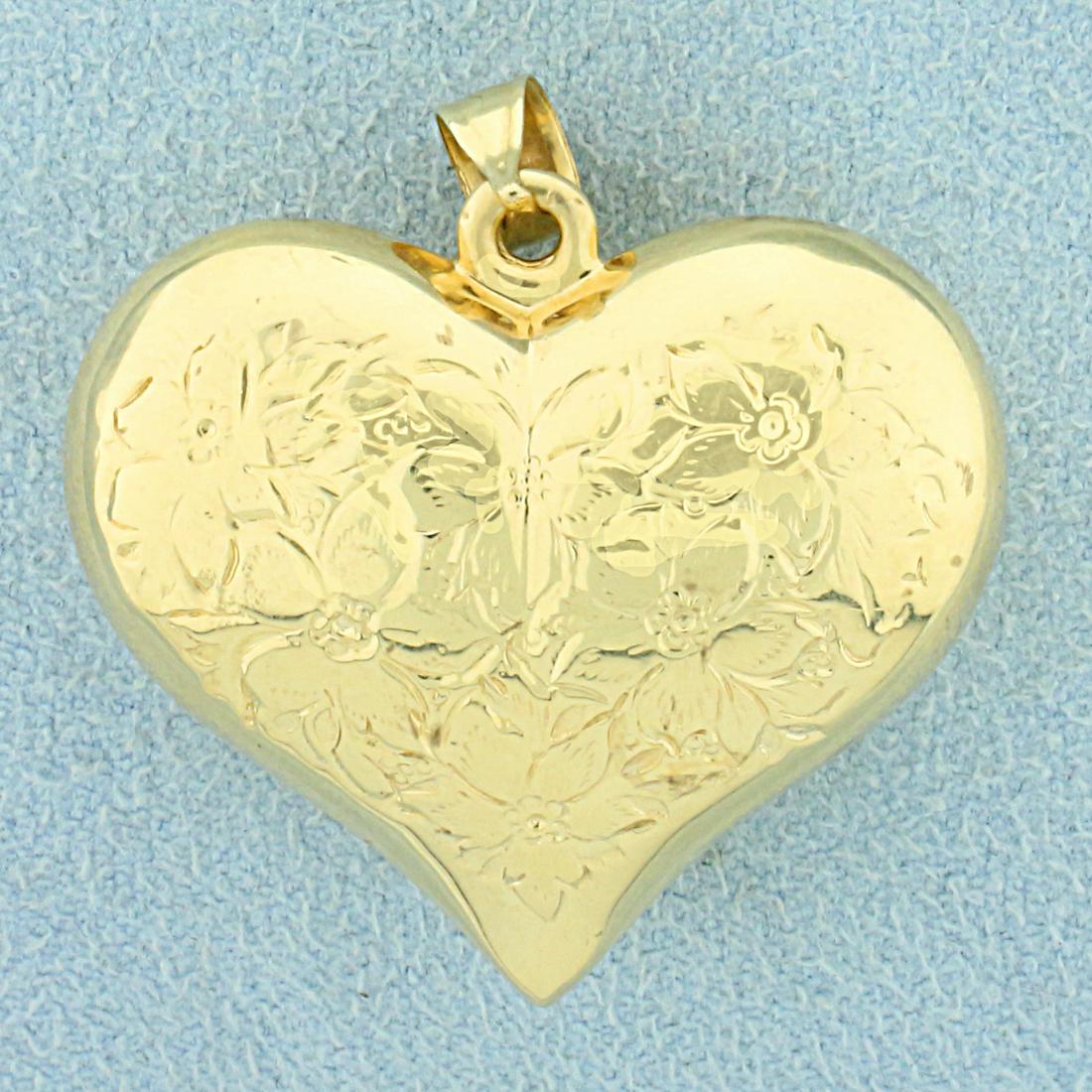Flower Engraved Heart Pendant in 14K Yellow Gold: In 14K Yellow Gold. 1 1/4 inches long including bale. 1 inch wide. 4.8g