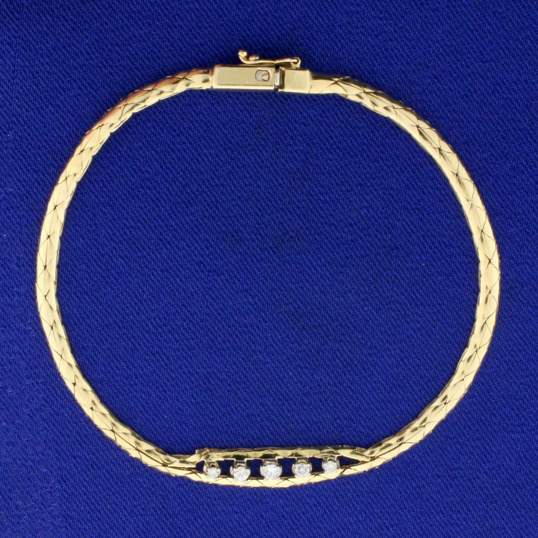 Italian-Made Diamond Cobra Link Bracelet in 14K Yellow: In 14K Yellow Gold. Contains five high quality diamonds, 1/8ct TW, VS clarity/H color. Cobra link chain. 7 1/8 inches long, 2.8mm-5.7mm wide. 5.5g.