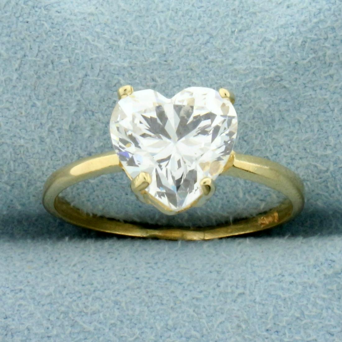3ct CZ Solitaire Heart Ring in 14K Yellow Gold: In 14K Yellow Gold. Contains one high quality natural 9.5mm heart shaped CZ gemstone with lots of sparkle and excellent clarity. Size 7 3/4. 2.6g