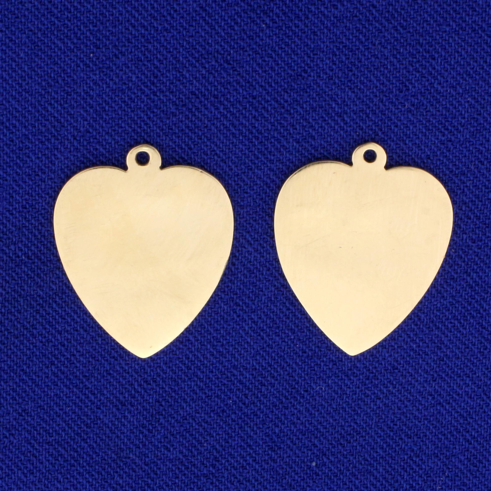 Two Heart Pendants or Charms in 14K Yellow Gold: In 14K Yellow Gold. 3/4 inch long.. 3.1g.