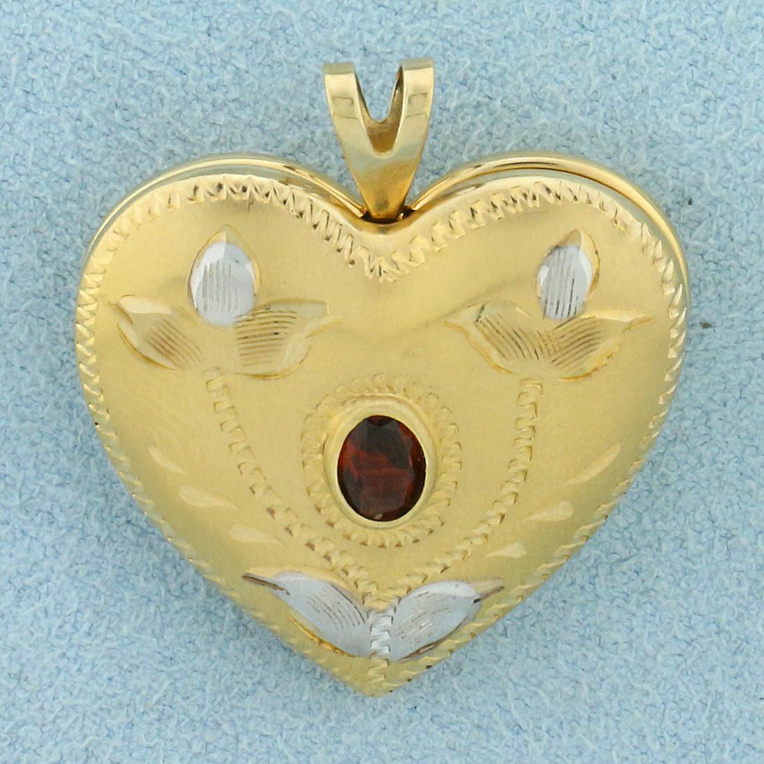 Vintage Garnet Heart Locket Pendant in 14K Yellow and: In 14K Yellow and White Gold. Contains one high quality natural 5 x 3.5mm oval cut Garnet gemstone with beautiful deep color and excellent clarity. 1 1/4 inches long including bale, 1 inch wide. 6.9g.