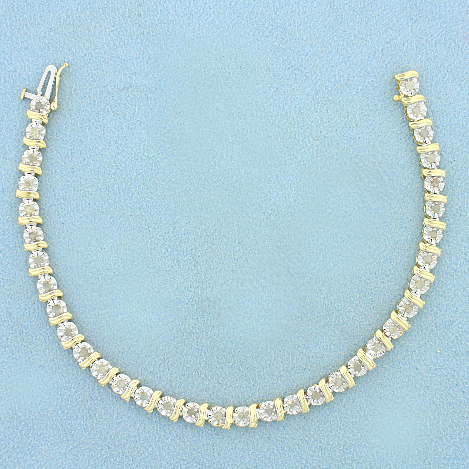 1/2ct TW Diamond Tennis Bracelet in 10K Yellow and: In 10K Yellow and White Gold. Contains thirty-five high quality diamonds, 1/2ct TW, J color/I2 clarity. 7 inches long, 5mm wide. Safety clasp. 6.3g.