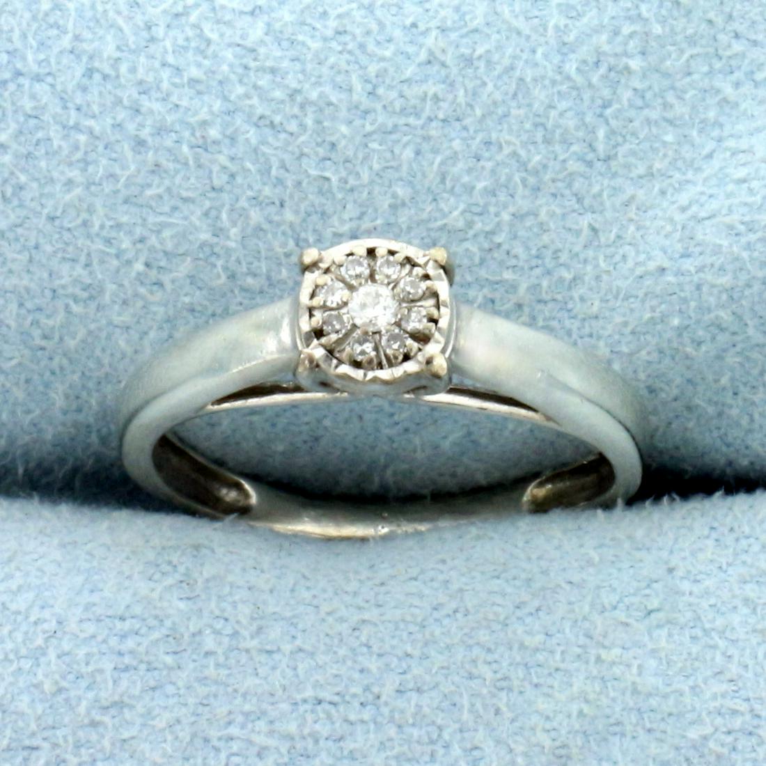 Diamond Illusion Ring in 10k White Gold: In 10k White gold. Contains one .02ct and eight 1/2 pt diamonds that look like one larger 1/3ct Solitaire diamond, I color/I clarity. Size 5 1/2. 1.9g.