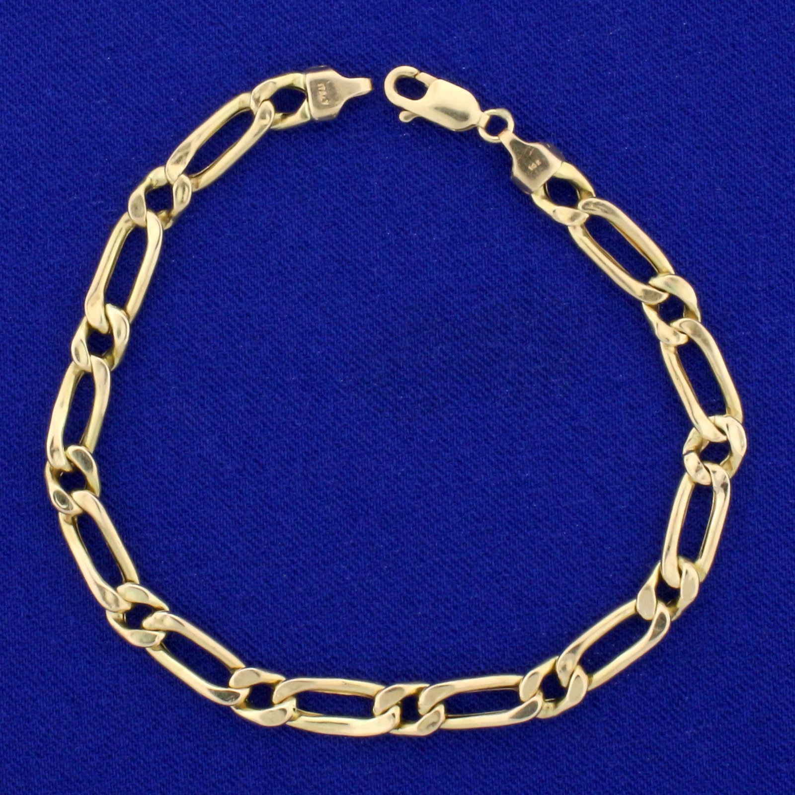 7 Inch Figaro Link Chain Bracelet in 14K Yellow Gold: In 14K Yellow Gold. 7 inches long, with lobster clasp. 5.3mm wide. 3.9g