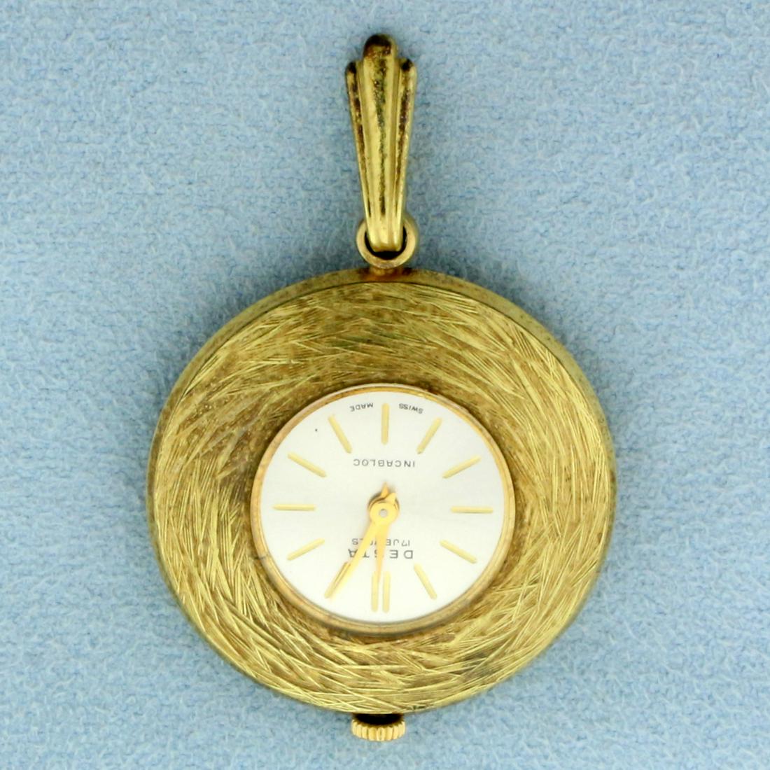 Vintage Desta 17 Jewel Manual Wind Incabloc Pendant: Gold Plated . Swiss made windup movement runs great. No scratching on crystal, overall great condition. 1 3/4 inch long including bale. 1 1/4 inch wide. 19.6g
