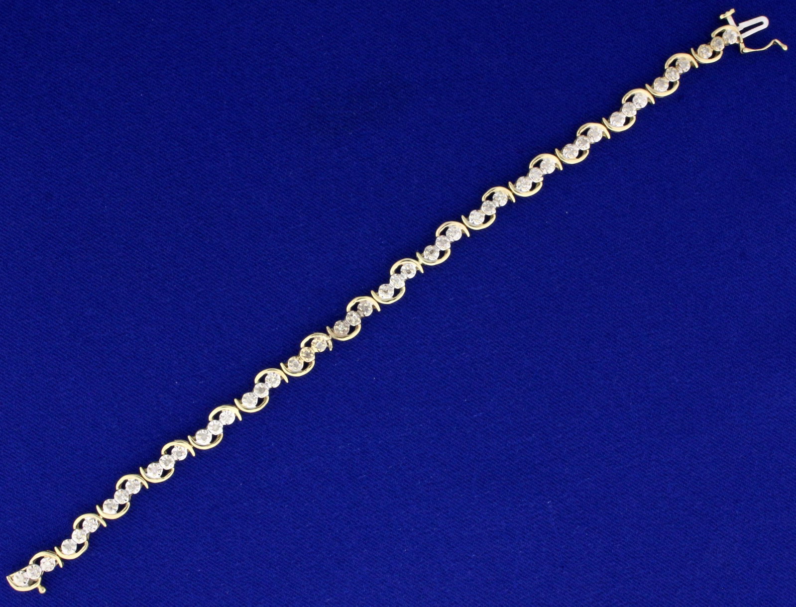 Diamond Tennis Bracelet in 10K Yellow and White Gold: In 10K Yellow and White Gold. Contains forty-eight Diamonds, 1/2ct TW, I color/I clarity. 7 inches long. Safety clasp. 6.2g
