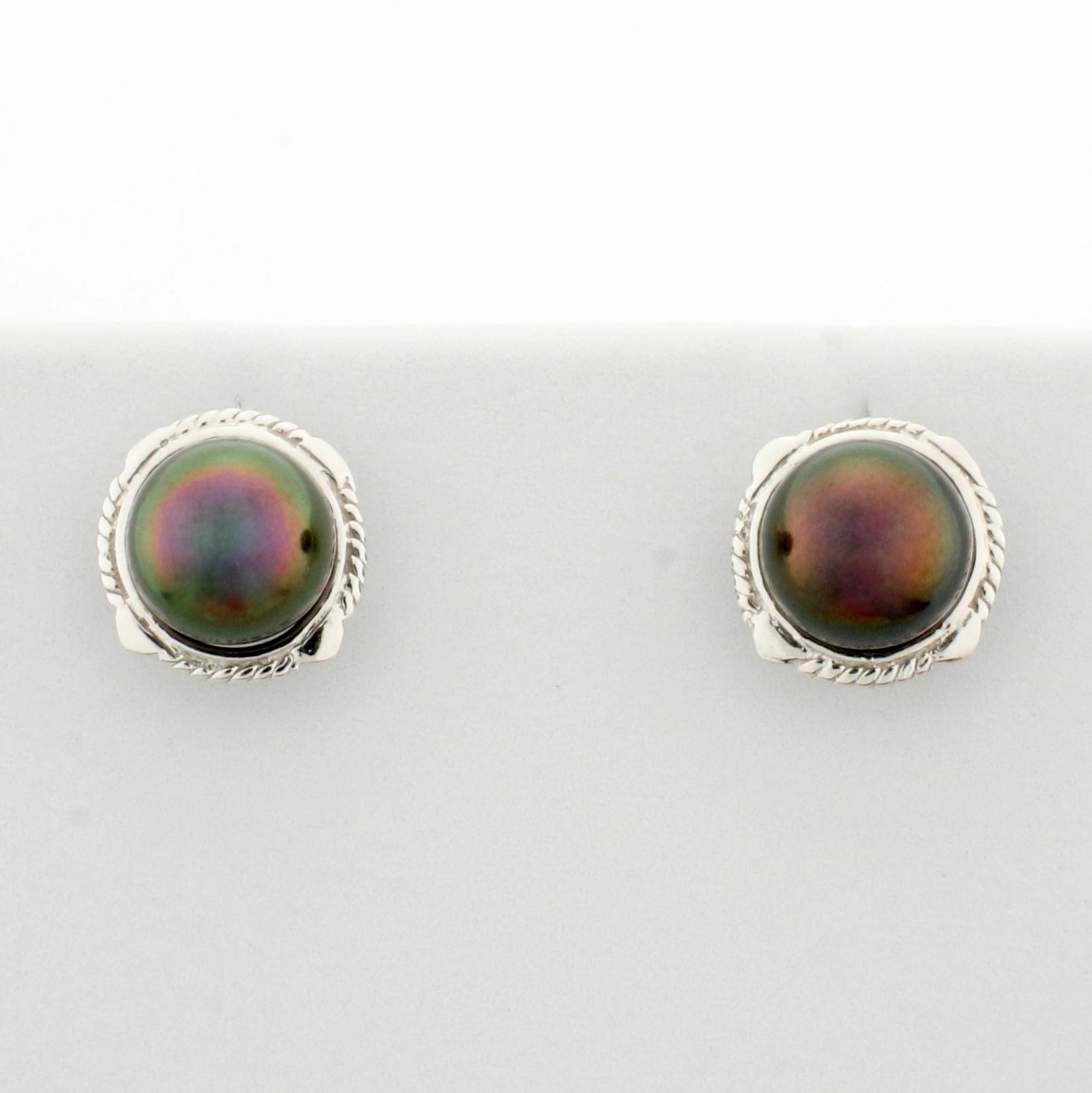 6.5mm Tahitian Pearl Earrings in 18K White Gold: In 18K White Gold. Each earring contains one high quality 6.5mm Tahitian Pearl with beautiful color and luster. Friction backs. 2.3g.