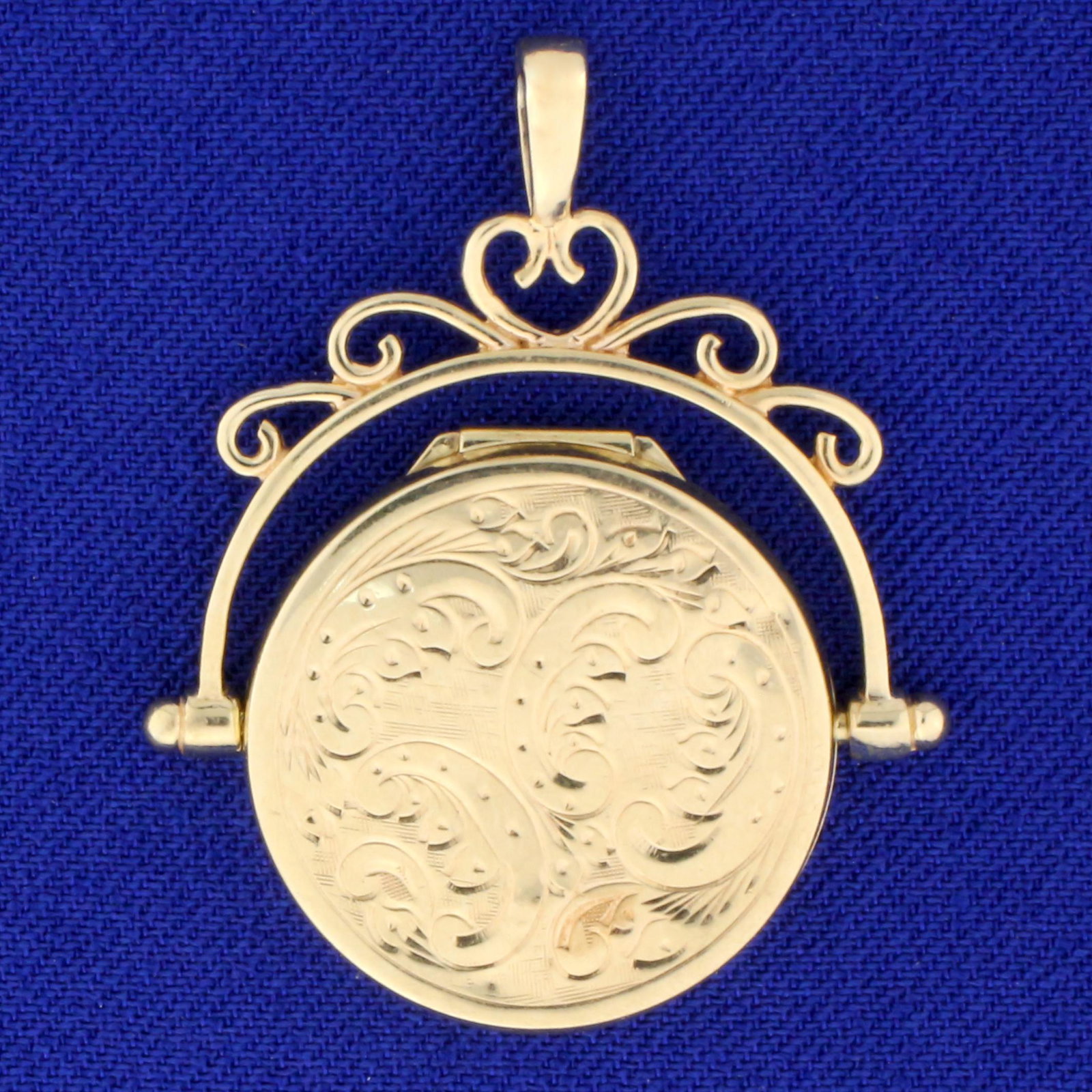 Elegant Floral Design Locket Pendant in 10K Yellow Gold: In 10K Yellow Gold. 1 3/8 inches long including bale, 1 1/8 inches wide. 3.5g.