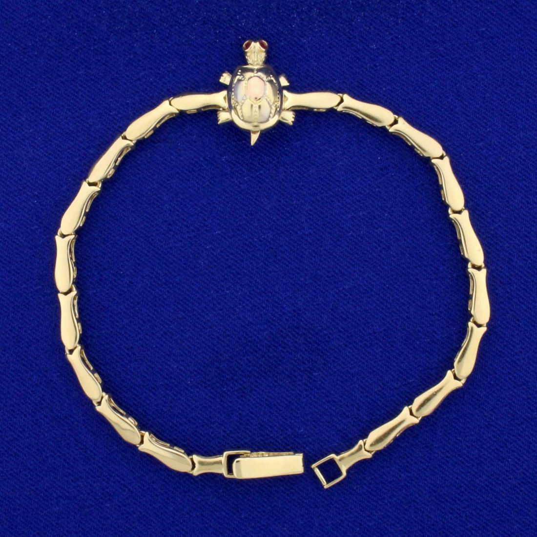 7 1/2 Inch Ruby Turtle Bracelet in 14K White, Yellow: In 14K White, Yellow, and Rose Gold. Contains two high quality natural 1.3mm round Ruby gemstones. 7 1/2 inches long. Bracelet links are 3.4mm wide. Turtle is 3/4 inch long. Turtle shell has white and