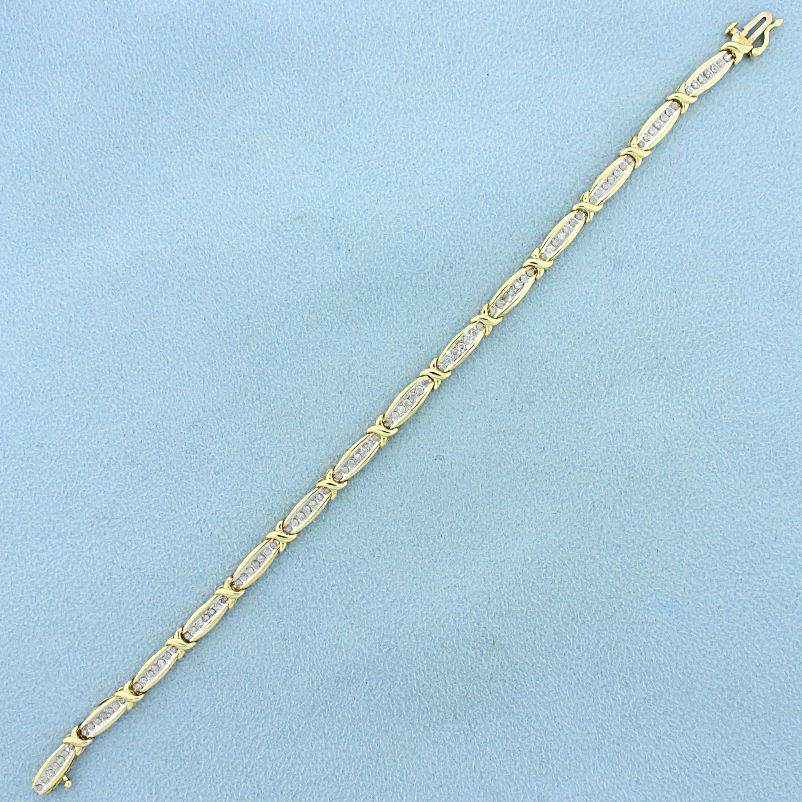 1ct TW Diamond Tennis Bracelet in 10K Yellow Gold: In 10K Yellow Gold. Contains ninety-eight high quality.01ct Diamonds, I clarity/I color. With safety clasp. 7 1/2 inches long. 4.5mm wide. 7.6g