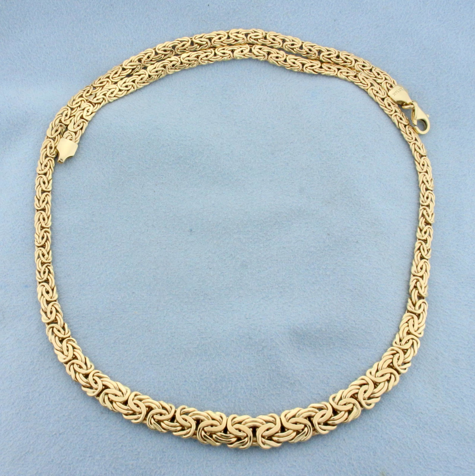 18 Inch Graduated Byzantine Link Chain Necklace in 14K: In 14K Yellow Gold. 18 inches long, 4.5mm wide to 8mm wide. Lobster clasp. 11.1g.
