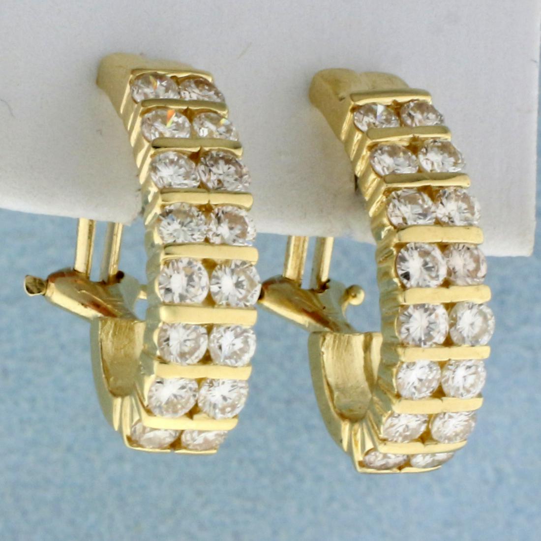 2ct TW Diamond Huggie J Hoop Earrings in 14K Yellow: In K Yellow Gold. Contains thirty two high quality Diamonds, 2ct TW, VS clarity/H color. 7/8 inches long. 5mm wide. Post with omega backs for pierced ears. 7.5g