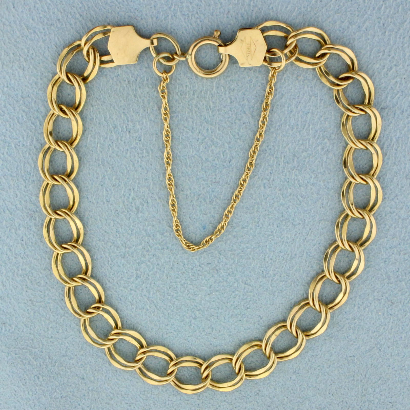 Double Cable Link Chain Charm Bracelet in 10K Yellow: In 10K Yellow Gold. With spring clasp and safety chain. 7 inches long. 6.6mm wide. 6.0g