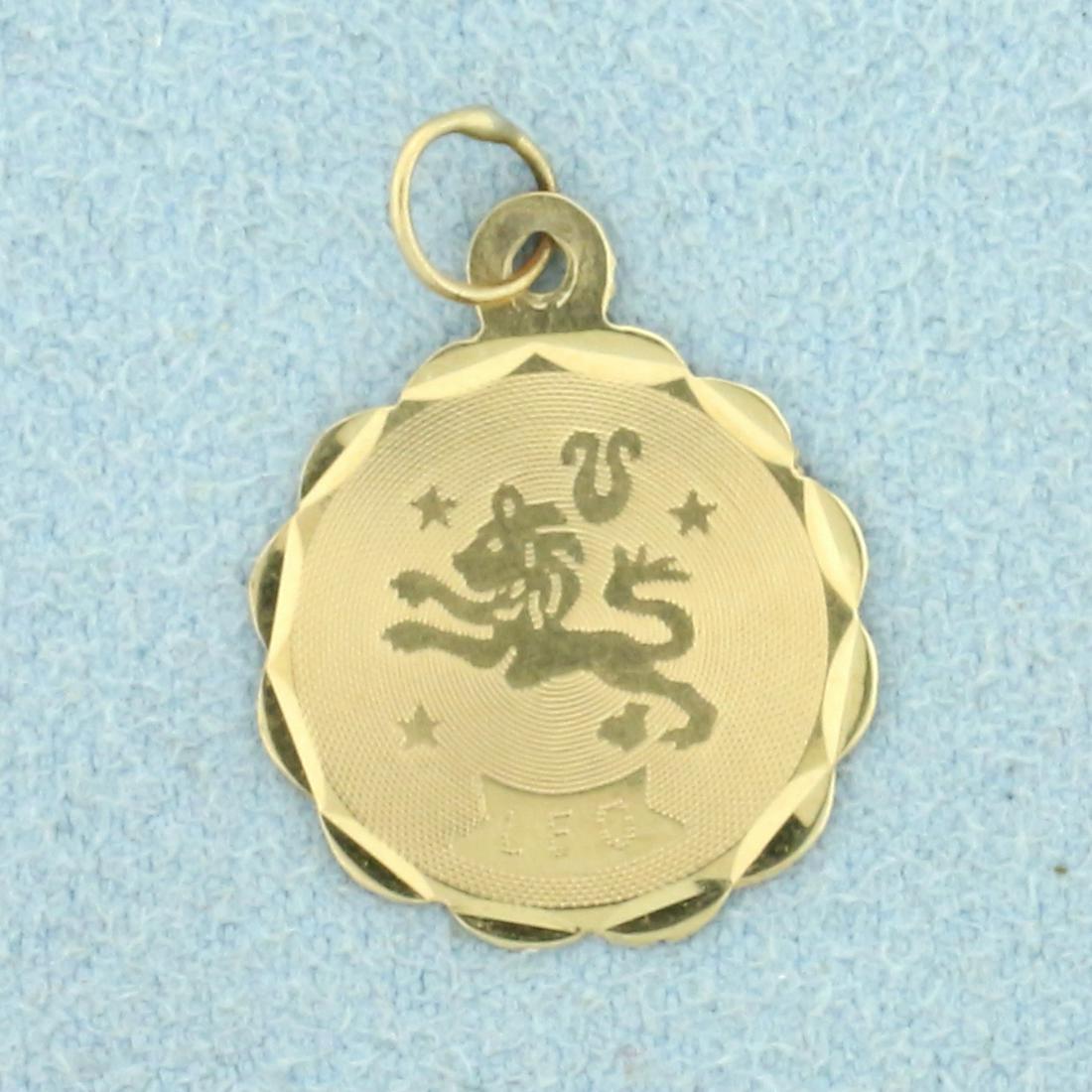 Leo Zodiac Pendant or Charm in 14K Yellow Gold: In 14K Yellow Gold. 3/4 inches long including jump ring. 5/8 inch wide. 0.5g