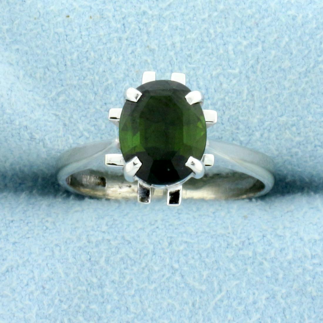 1.5ct Tsavorite Garnet Solitaire Ring in 14K White Gold: In 14K White Gold. Contains one high quality natural 8.5x7mm oval Tsavorite Garnet gemstone with intense green color and excellent clarity. Size 6. 3.6g.