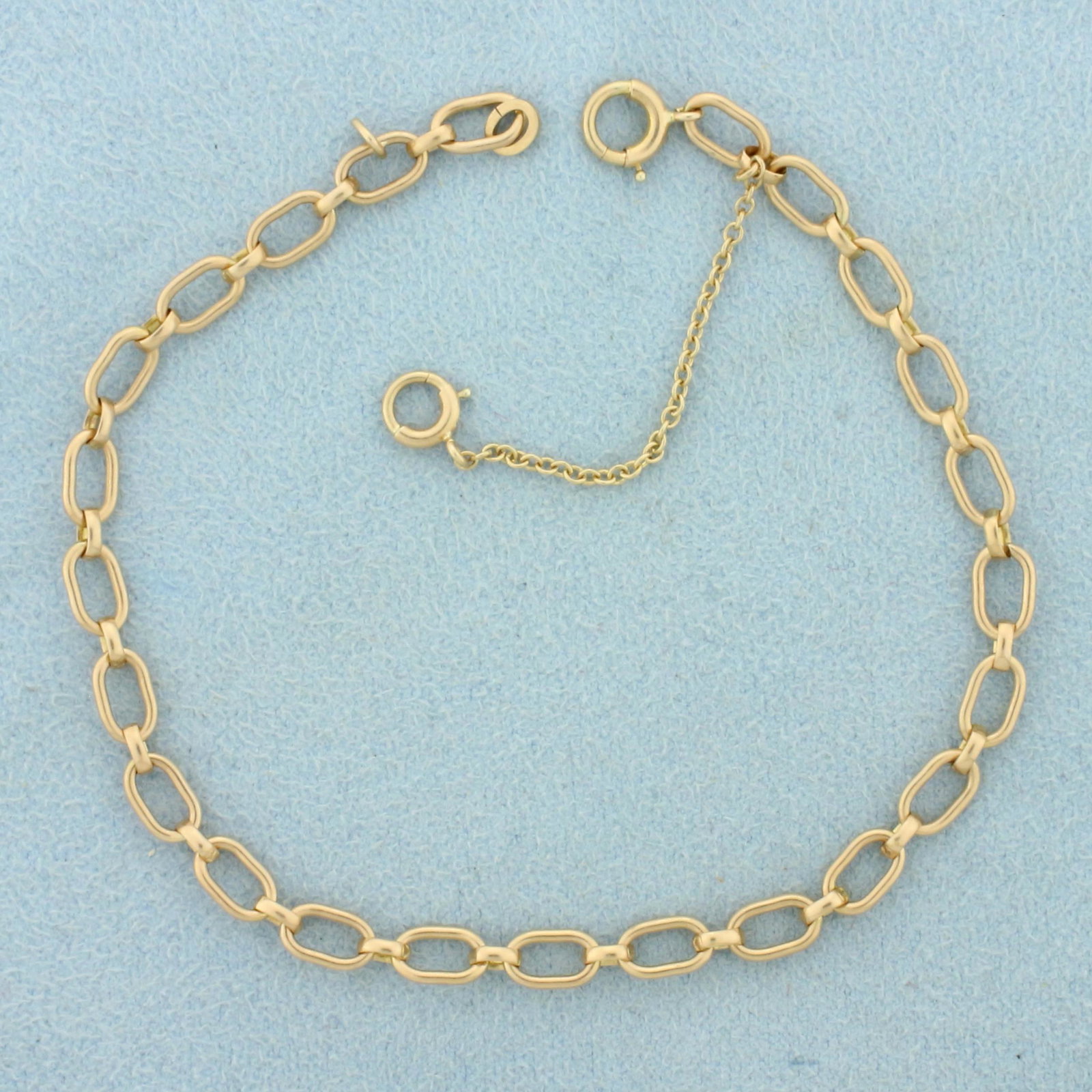 Elongated Cable Link Chain Bracelet In 14K Yellow Gold: In 14K Yellow Gold. With Safety Chain. 7 inches long. 4.1g