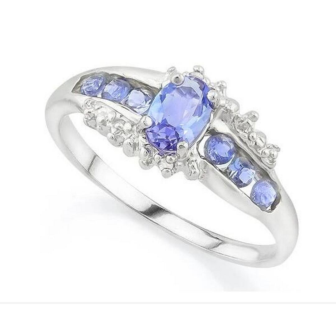 Tanzanite & Diamond Ring in Sterling Silver: Oval cut .45ct tanzanite gemstone ring accented with .24ctw round cut tanzanite gems and .01ctw genuine diamond. Size 8. Set in platinum over sterling silver, 2.1g.