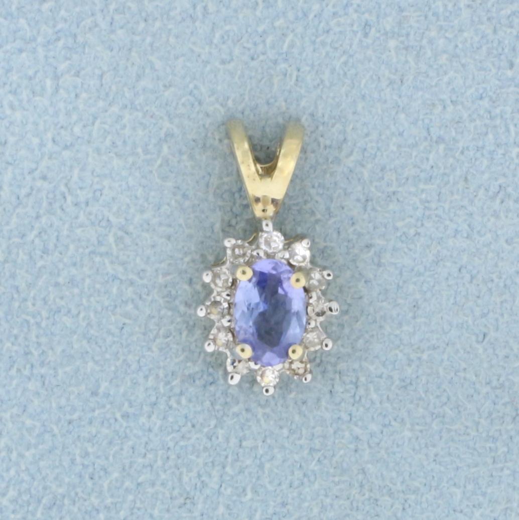 Tanzanite and Diamond Pendant in 14k Yellow Gold: In 14k Yellow Gold. Contains one high quality natural 6x4mm oval Tanzanite gemstone with bright color and excellent clarity. Also contains twelve high quality 1/2pt Diamonds. 5/8 inch long, 3/8 inch w