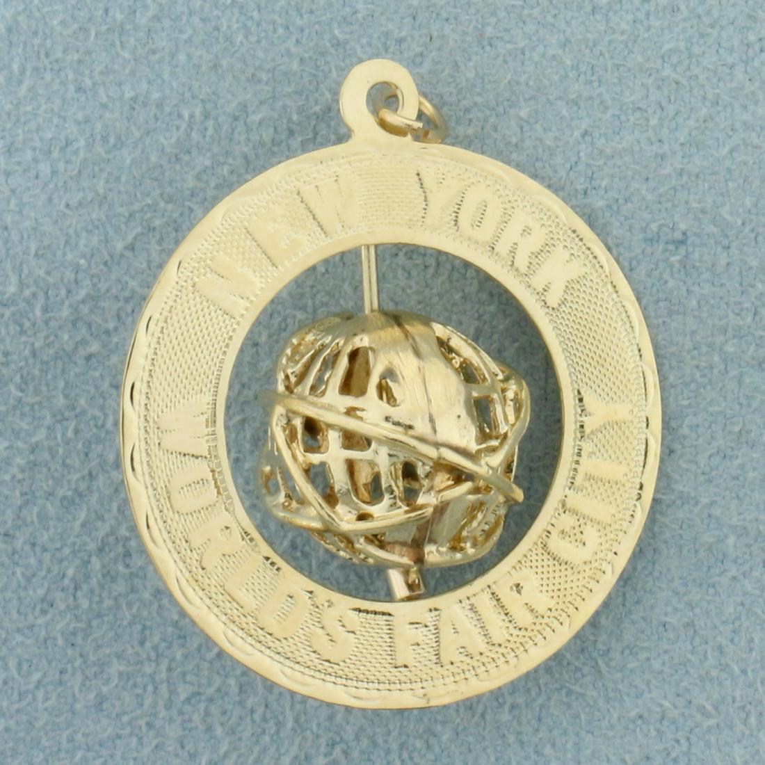 Mechanical 3D New York City World's Fair Pendant or: In 14K Yellow Gold. World spins. 1 1/4 inches long with jump ring, 1 inch wide. 3.3g.