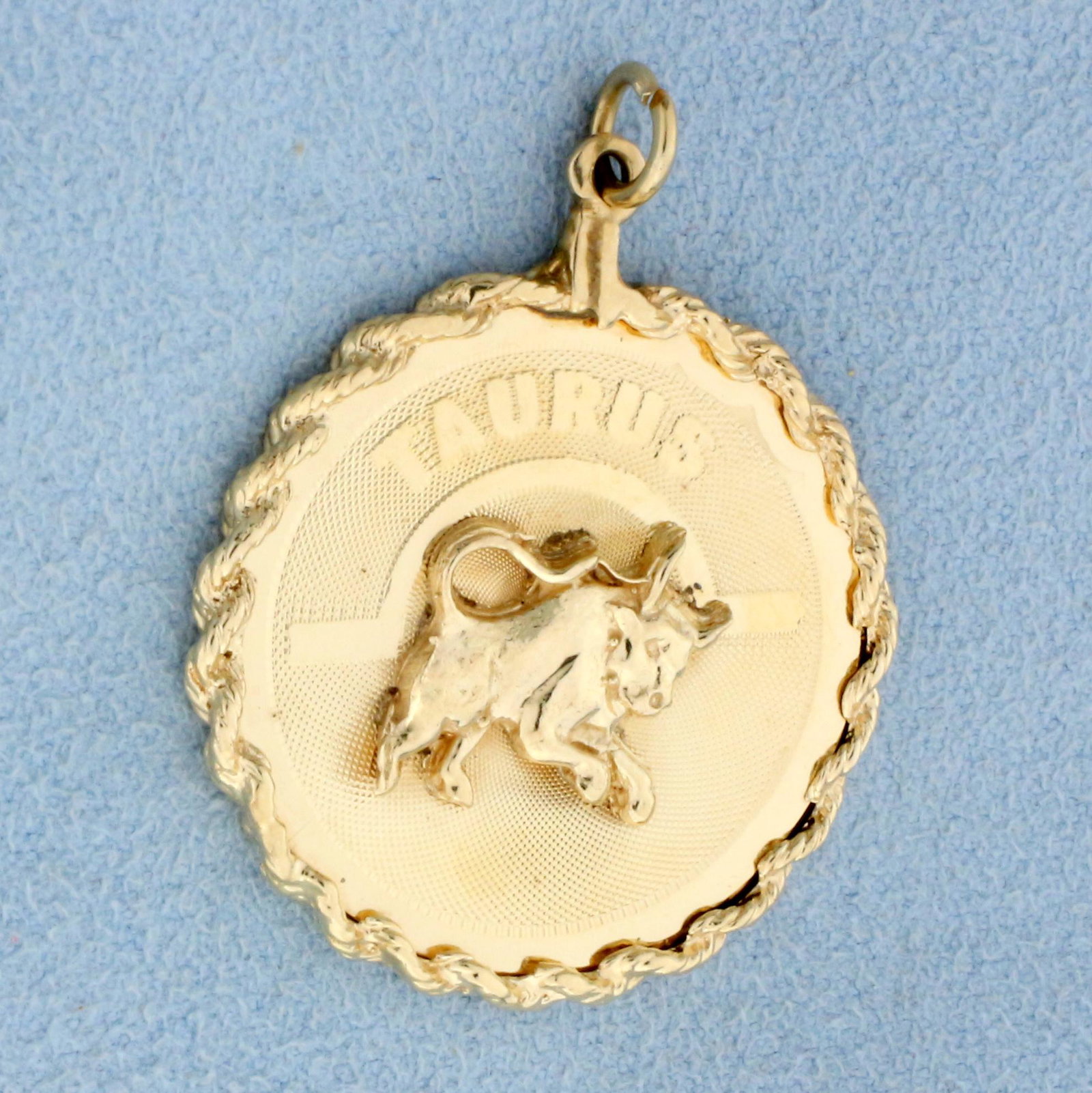 Astrology Taurus The Bull Pendant in 14K Yellow Gold: In 14K Yellow Gold. 1 1/2 inches long including jump ring, 1 1/8 inches wide. 4.9g.