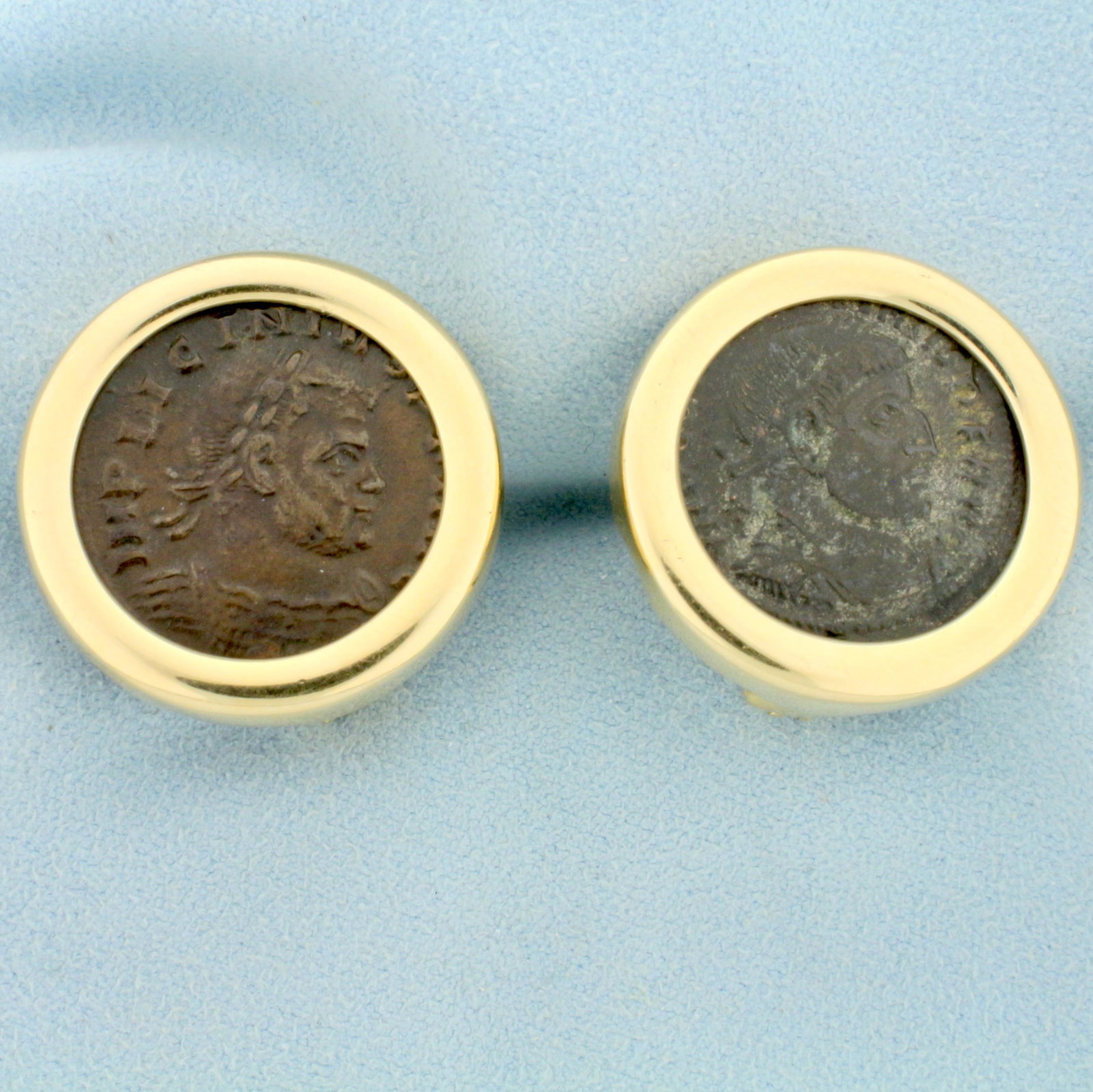 Roman Bronze Ae Coin Earrings in 14K Yellow Gold: In 14K Yellow Gold. Each earrings contains one Roman Bronze "Ae" coin from the 3rd or 4th century. Coins are 3/4 inch diameter. French omega backs for pierced ears. 17.0g